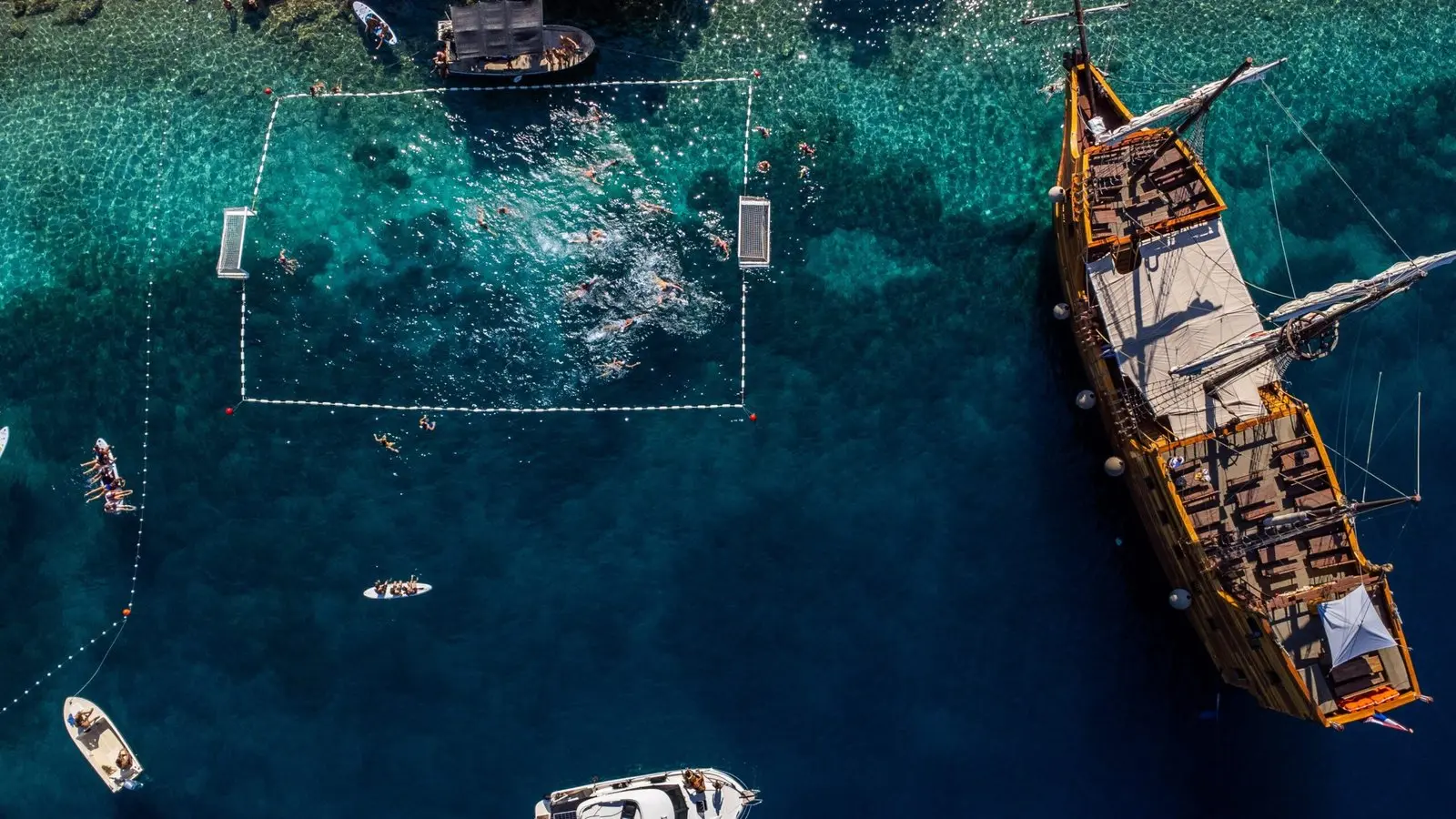 Aerial view of the Priježba sea court on Šipan with a pirate boat anchored in the bay