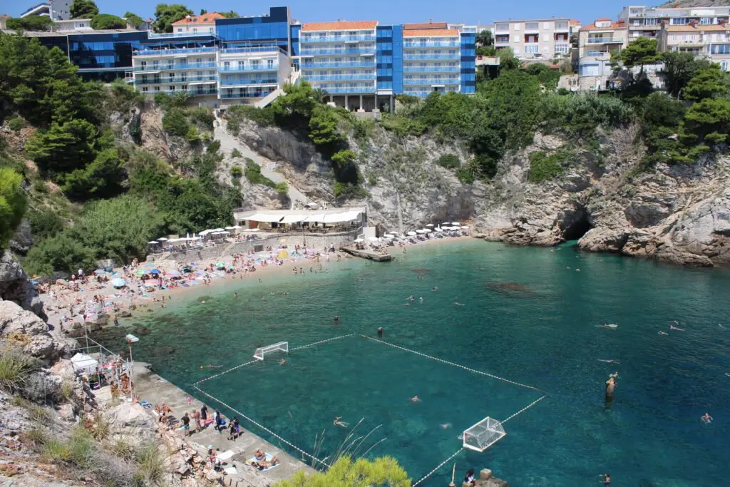 The natural sea pool at Bellevue beach in Dubrovnik, surrounded by cliffs
